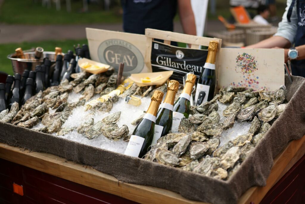 Elegant Display Of Champagne Bottles And Fresh Oysters At An Outdoor Market Offe 1 1024x683