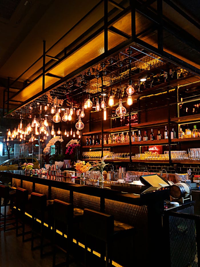 Crafting Captivating Headlines: Your awesome post title goes here Contemporary bar with warm lighting, showcasing a chic interior with stocked shelves and stylish decor.